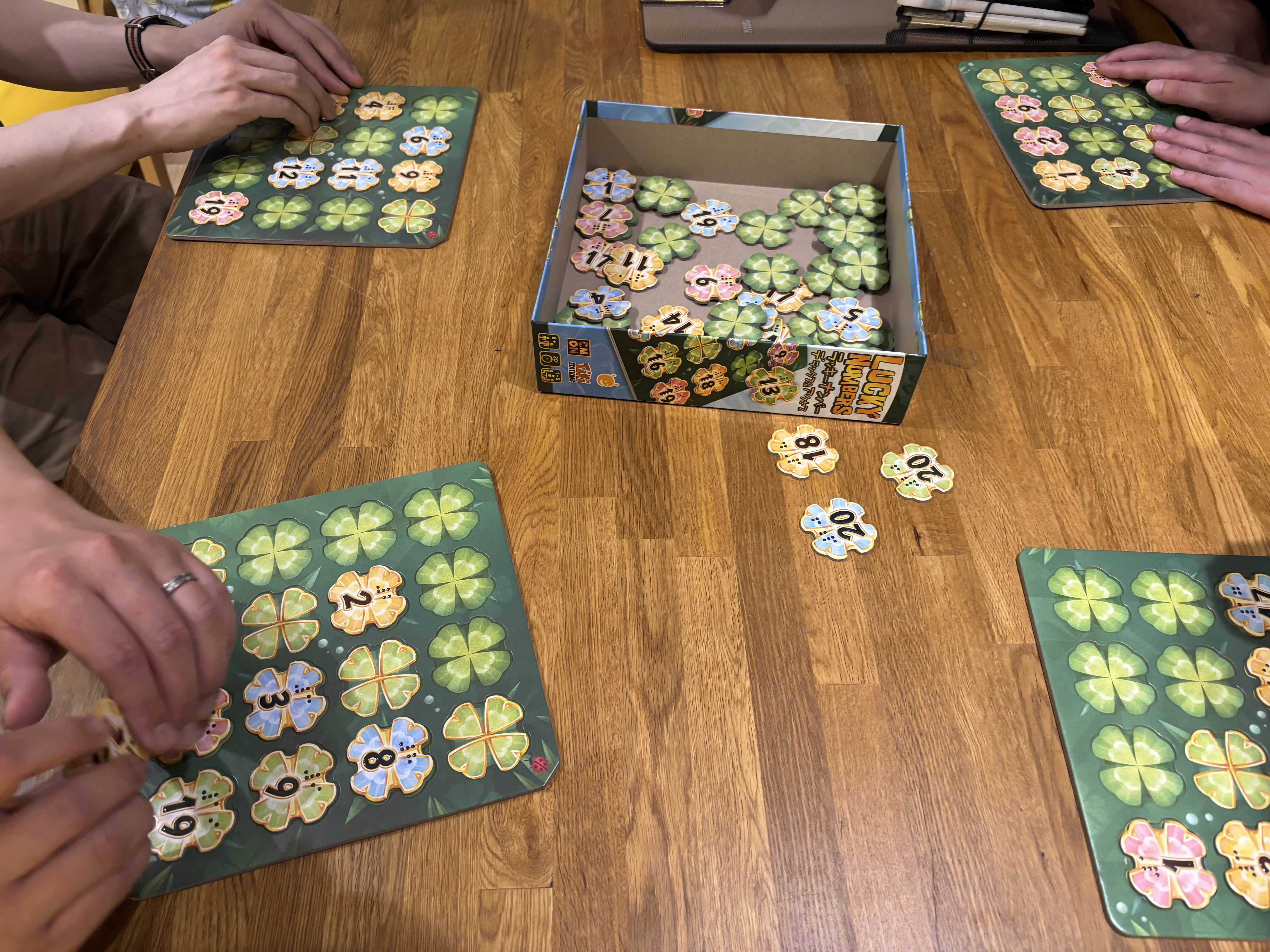 People playing "Lucky Numbers" game, arranging clovers according to set rules